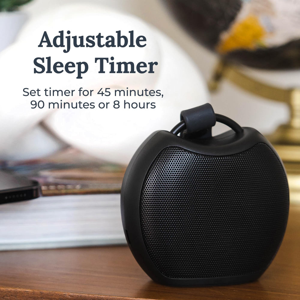 Yogasleep Rohm+ travel near charging pad showing wireless charging option.