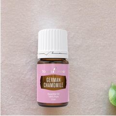 Young Living German Chamomile amber glass bottle signals premium essential oil.