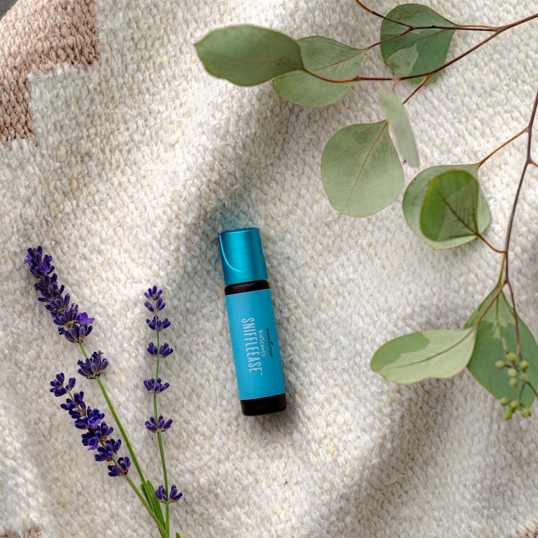 Young Living KidScents SniffleEase bottle on table showing travel-friendly design.