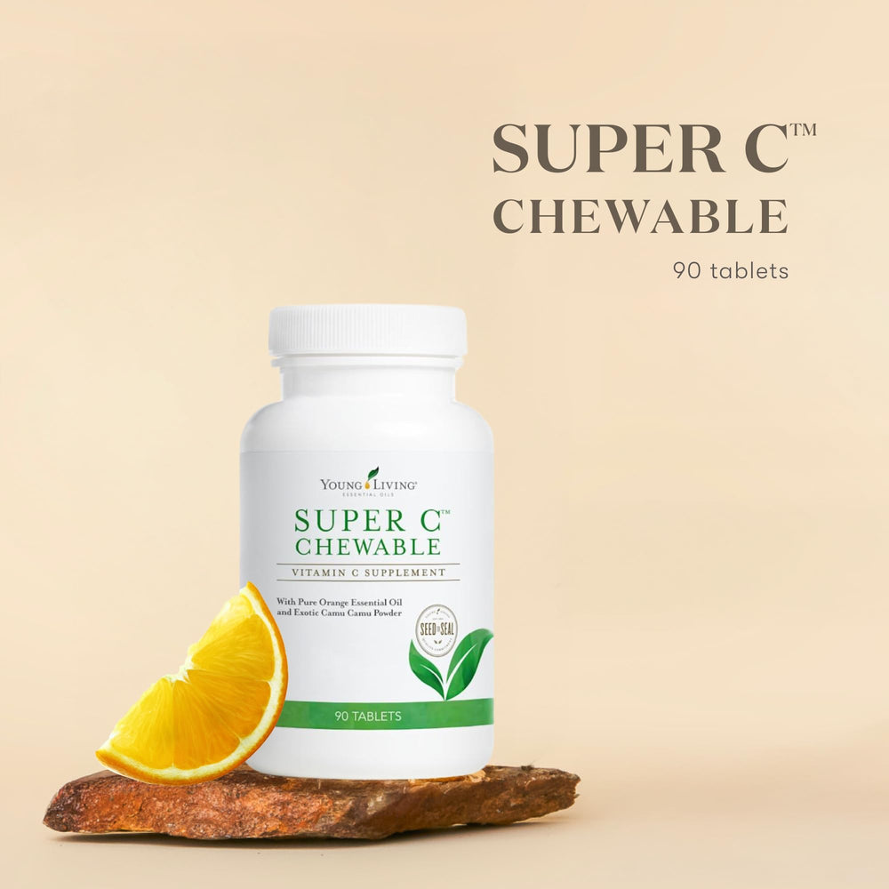 Young Living Super C chewable tablets on fruit backdrop highlighting citrus flavor