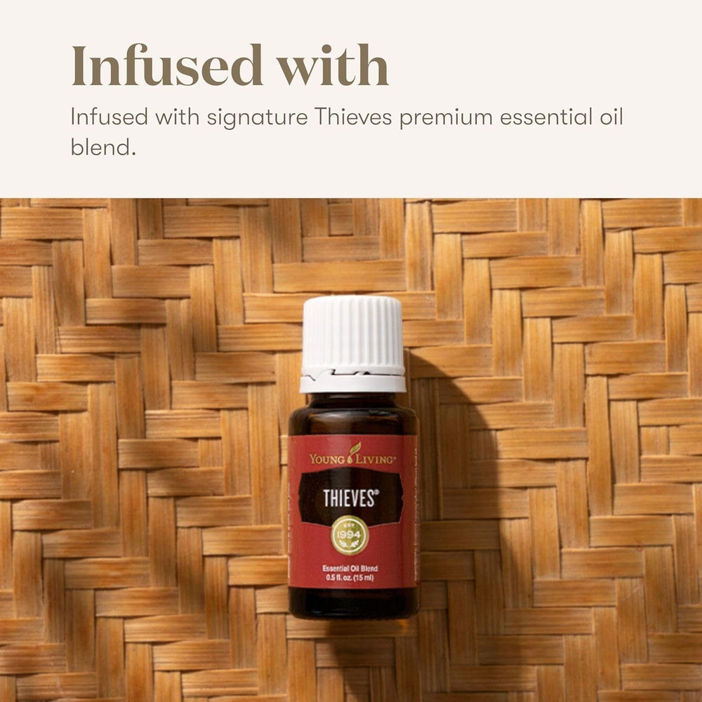 Hand holding Young Living Thieves Cough Drops for travel-friendly use.