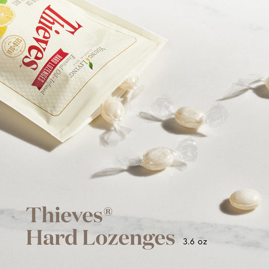 Young Living Thieves hard lozenges bottle and tin on desk suggest convenient sugar-free relief